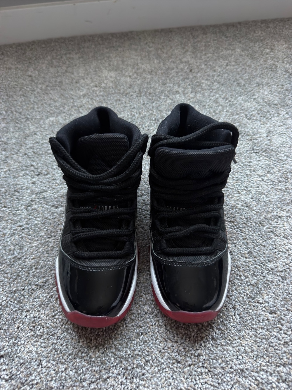 4.5Y Women’s 6 Jordan Bred 11s Black and Red High-Top Sneakers